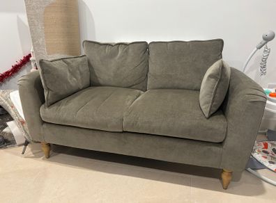 Sage green sofa ideal for small spaces