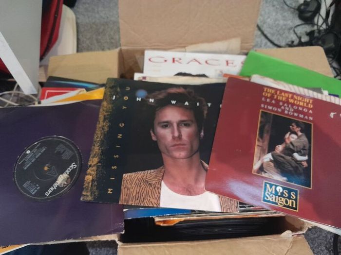 a box of 7" singles. 45 rpm vinyl records.