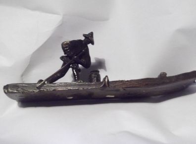 a vintage chinese bronze of  fishing man on a bamboo boat signed
