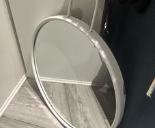 Round HAY Strap Mirror No. 2 in white with a gold-finish wall mount.