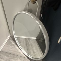 Round HAY Strap Mirror No. 2 in white with a gold-finish wall mount.