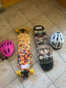 2 skateboards with helmets