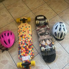2 skateboards with helmets
