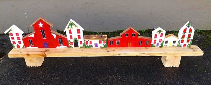 rustic wooden floating shelf display featuring a hand-painted village scene