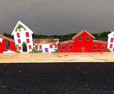 rustic wooden floating shelf display featuring a hand-painted village scene