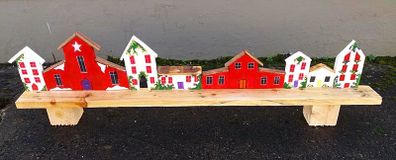 rustic wooden floating shelf display featuring a hand-painted village scene