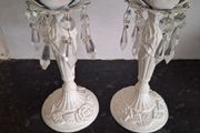 A pair of metal and crystal candleholders