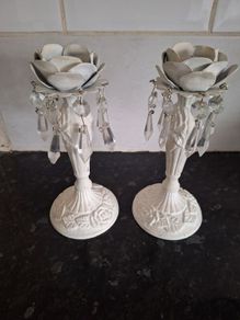 A pair of metal and crystal candleholders