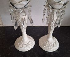 A pair of metal and crystal candleholders