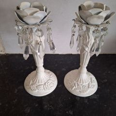 A pair of metal and crystal candleholders