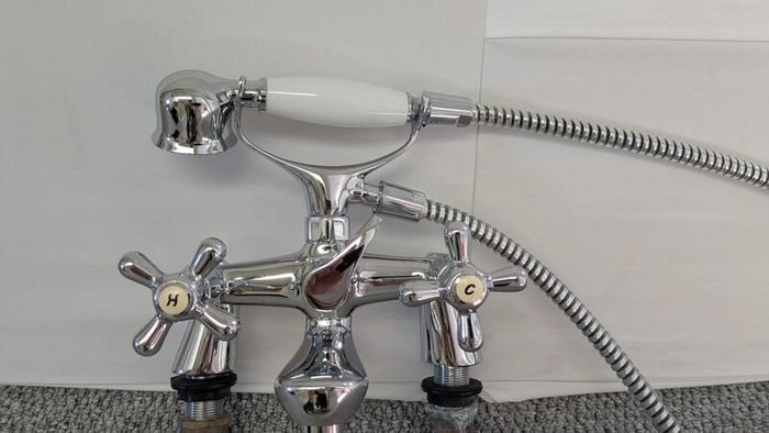 Retro bath mixer with handheld shower head.