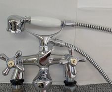 Retro bath mixer with handheld shower head.