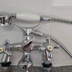 Retro bath mixer with handheld shower head.