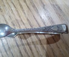 ornate silver sugar tongs