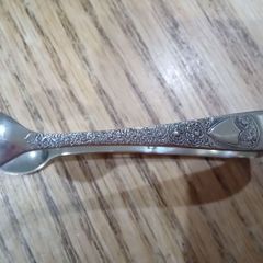 ornate silver sugar tongs
