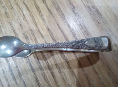 ornate silver sugar tongs