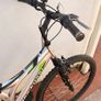 Rockway mountain bike silver and black frame with green accents and a full suspension system. Image 4