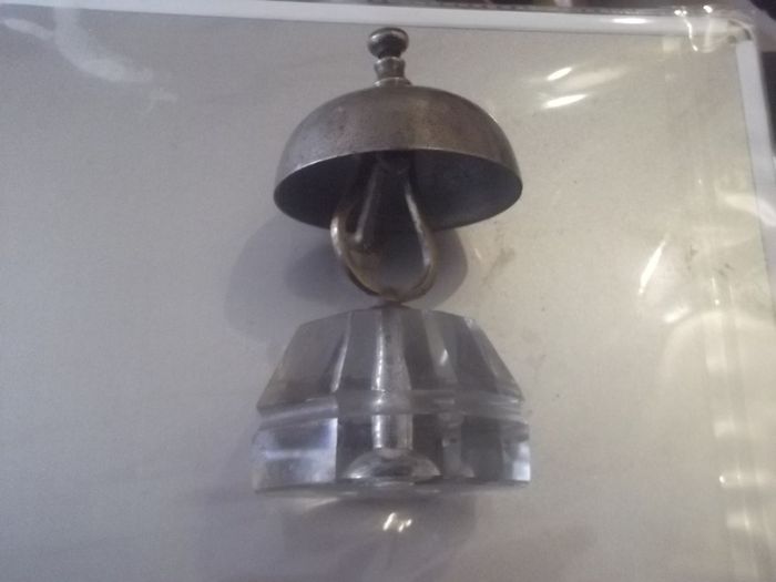 a antique counter bell with a cut glass base