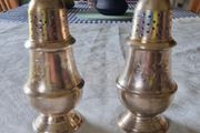 A pair of silver-plated salt shakers