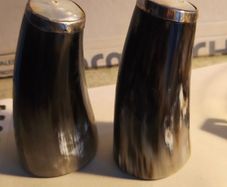 Set of 2 Buffalo Horn  Salt And Pepper Set topped with mother of pearl rimmed with sterling silver rim stamped.