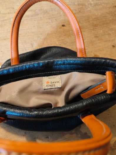 David Jones  is a classic, two-tone black pebbled Faux leather bucket bag.