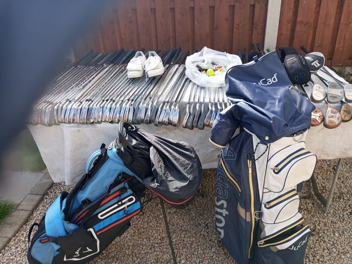 A selection of golf clubs and bags. All right handed clubs.