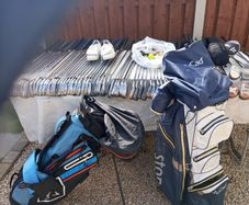 A selection of golf clubs and bags. All right handed clubs.