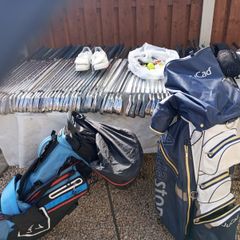 A selection of golf clubs and bags. All right handed clubs.