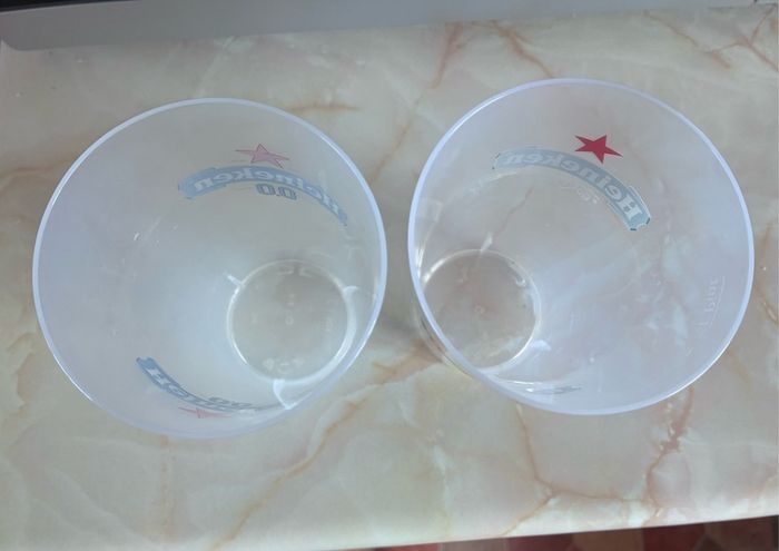 2 plastic Heineken glasses