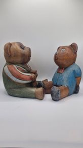 Two woodenc teddy bears