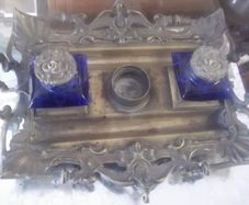 a solid antique brass ink stand with bristol blue ink holders