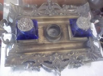 a solid antique brass ink stand with bristol blue ink holders