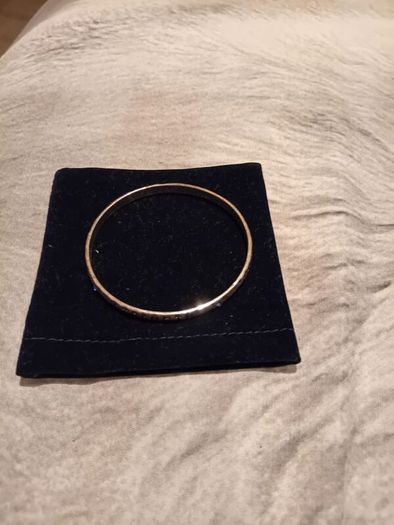 Silver tone bracelet with blue stones and words on it