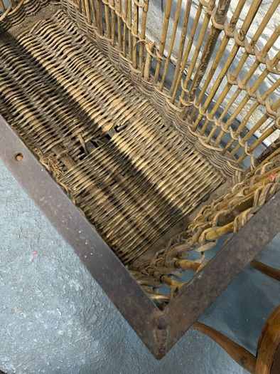 Large Victorian cane and metal laundry basket on wheels.