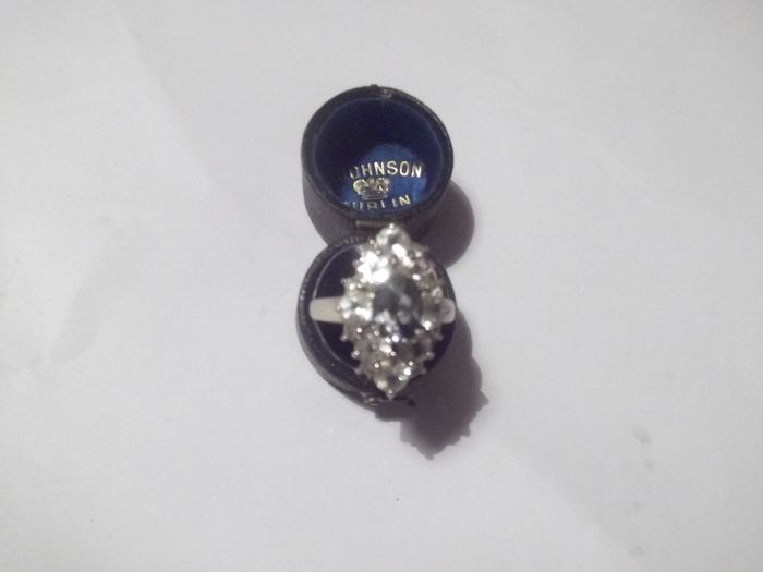 a silver dress ring with white stones  and a green stone stamped 925 china