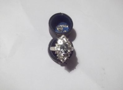 a silver dress ring with white stones  and a green stone stamped 925 china