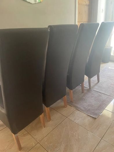 4 dark brown dining room chairs & 4 stretch covers