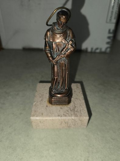 Copper Sacred art statue of Saint Francis of Assisi on marble plinth.