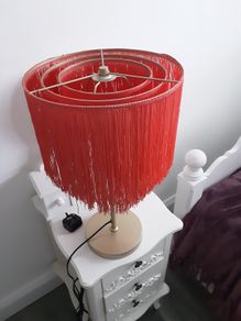 Orange fringed lamp on bass base