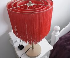 Orange fringed lamp on bass base