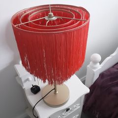 Orange fringed lamp on bass base