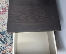drawers in a black-brown wood veneer finish glass top