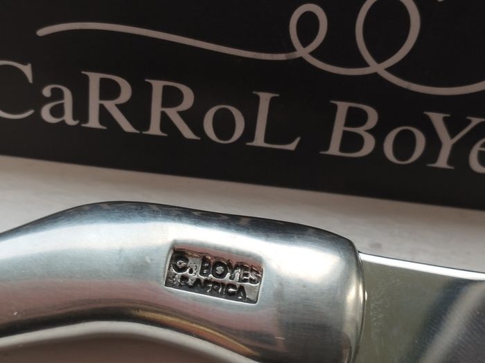 A collectible knife made of polished pewter with a stainless steel blade from Carrol Boyes.