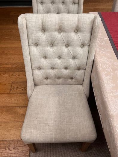 Cream button backed Kitchen chairs.