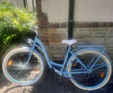 This is a B'TWIN Elops city bike, a fully-equipped urban commuter in a light blue color.
