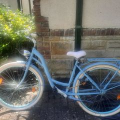 This is a B'TWIN Elops city bike, a fully-equipped urban commuter in a light blue color.
