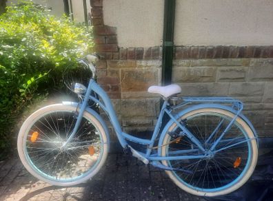 This is a B'TWIN Elops city bike, a fully-equipped urban commuter in a light blue color.