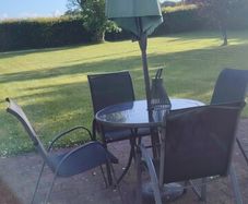 Glass table and 4 chairs. Can have umbrella and stand if want