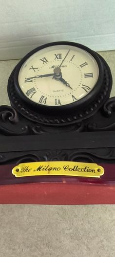 Vintage Bronze-toned Table Clock - Quartz Movement with Wooden Base by The Milano Collection in working order.