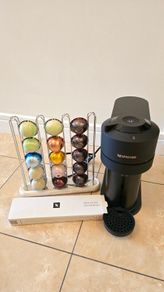 Nespresso Vertuo Next coffee machine with capsule holder and pods to taste